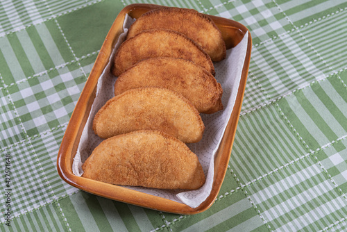 Brazilian chicken pastel on the table photo