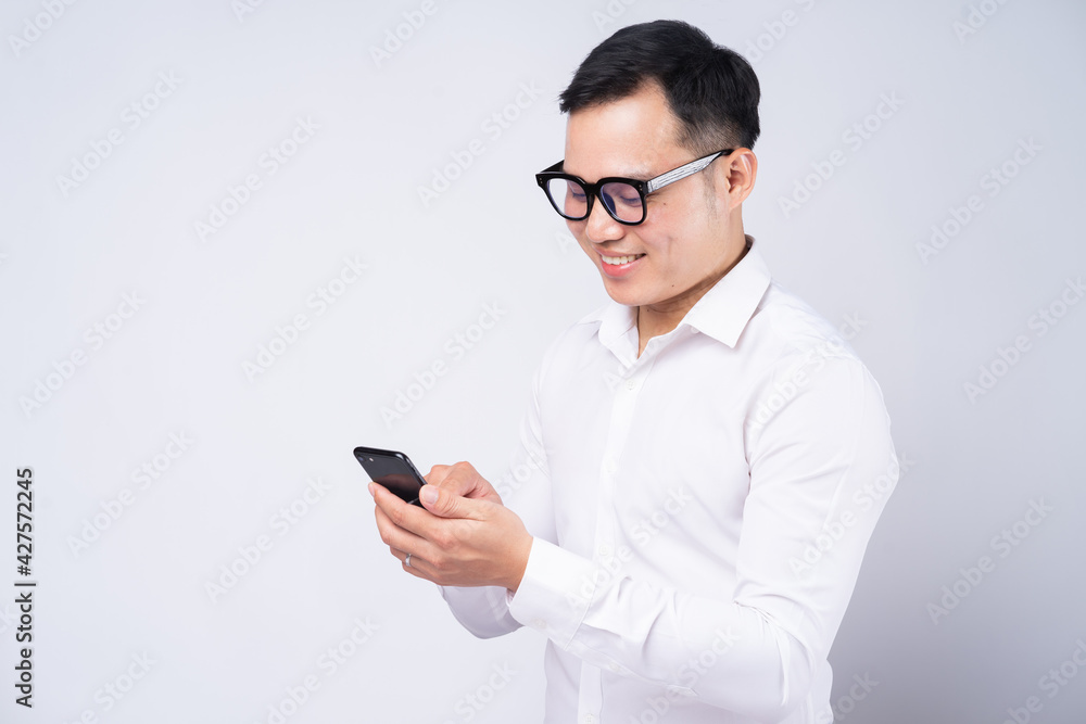 Asian businessman using smartphone on white background Asian businessman using smartphone on white background