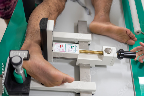 Doctor using stress test in ankle instability patient with chronic ankle sprain.The force was apply before radiographic study.