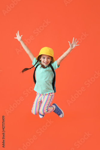 Jumping little girl with ba...