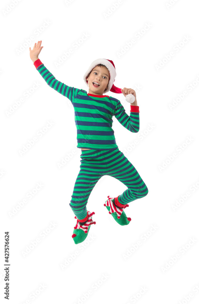 Jumping little boy in Christmas elf costume on white background