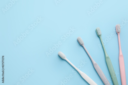 Tooth brushes on color background © Pixel-Shot