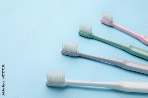 Tooth brushes on color background