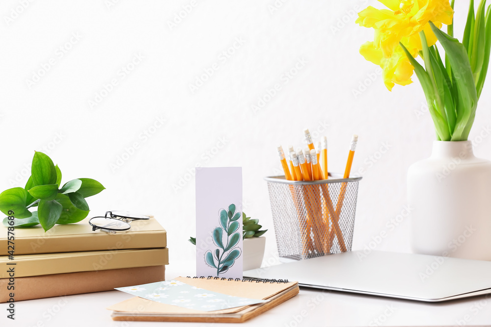 Stationery and flowers on table in office - obrazy, fototapety, plakaty 
