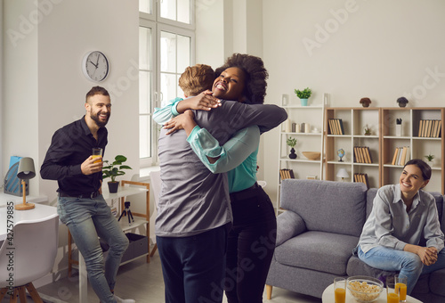 Obraz na plátne I'm so happy for you: African American woman embracing young Caucasian man and smiling