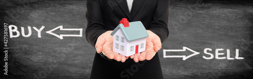 Real estate broker showing miniature house for buy and sell home housing market concept. Panoramic banner on black blackboard woman holding home with graphic design.