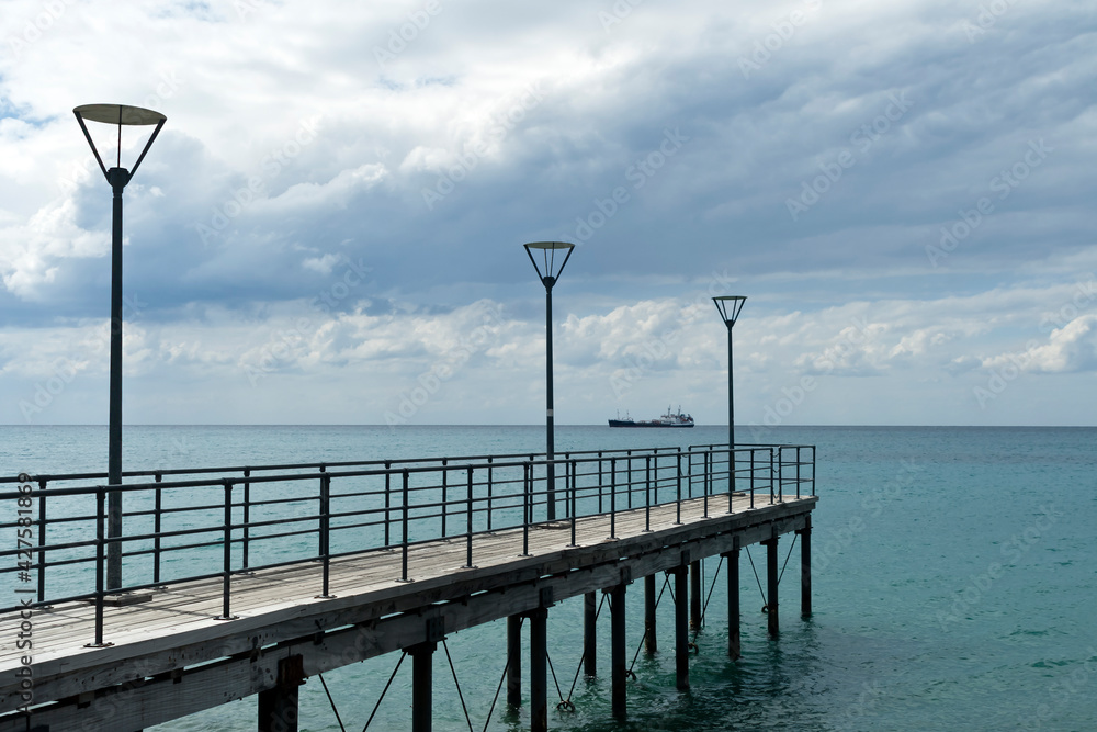 Empty sea pier with street lamps and scenic cloudscape, Limassol, Cyprus