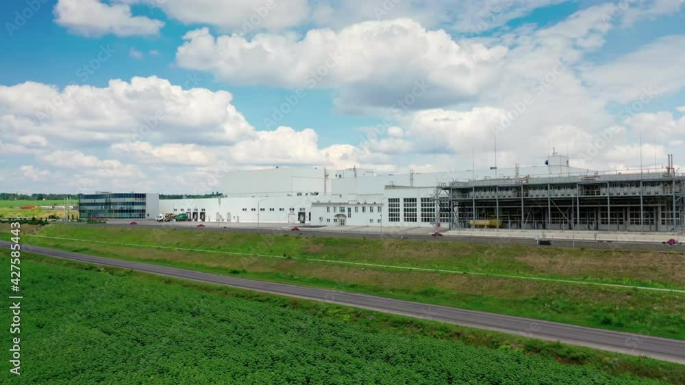 Contemporary industrial factory. Exterior of a large modern production plant in the countryside. Modern production company outdoors. Aerial view. Contemporary industrial factory. Exterior of a large modern production plant in the countryside. Modern production company outdoors. Aerial view.