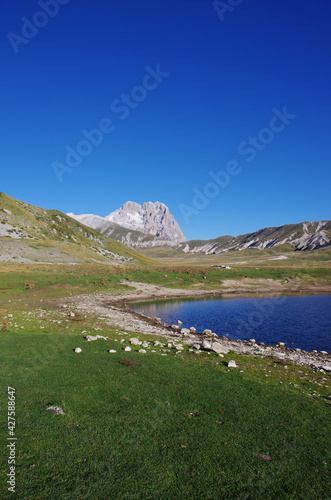 In the foreground the Pietranzoni lake and in the background the peak of the Corno Grande. Campo Imperatore, Gran Sasso plateau, Abruzzo, Italy.