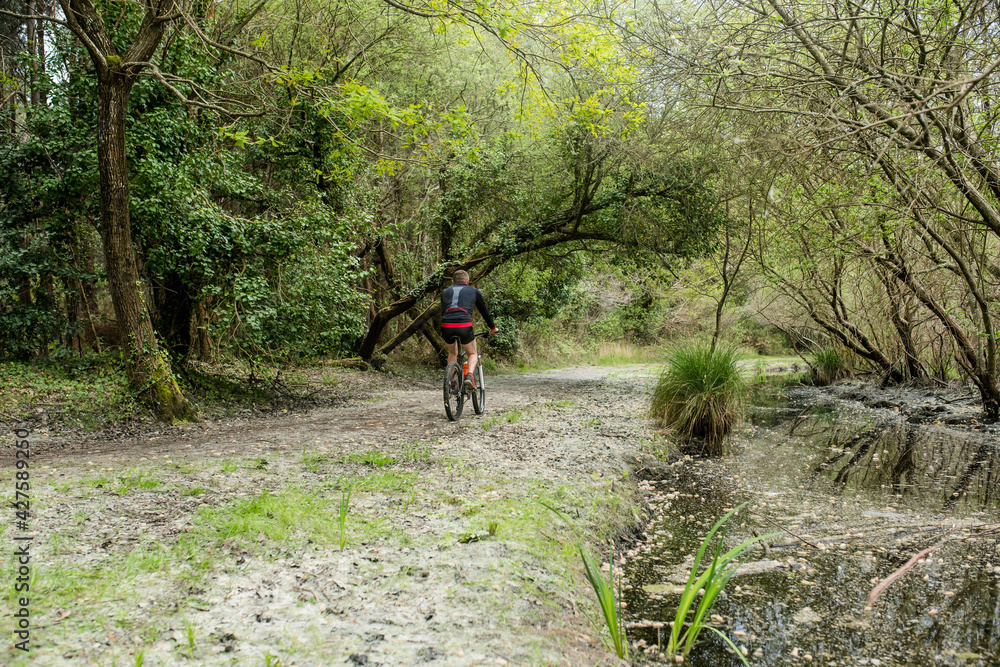 middle-aged man mountain biking in a wonderful setting middle-aged man mountain biking in a wonderful setting