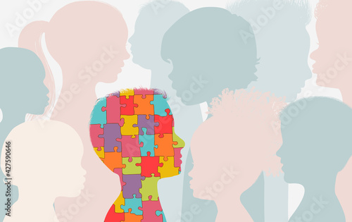 Autism syndrome concept. Jigsaw Puzzle that forms the head of a child s profile With other children background. Learning support and education. Neurological Disease. Mind and brain