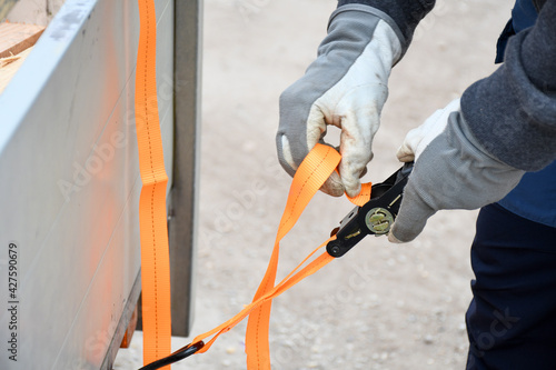 Canvas Print Action non focus fixing trailer strop or strap in orange nylon and metal, object helping for holding stuff , storage and transport for safty and security