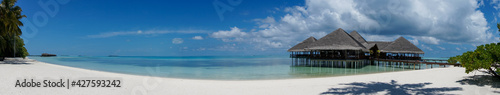 Turquoise lagoon on a maldivian island. Beautiful sky and clouds and beach background for summer vacation holiday and travel concept. Panoramic view © mathilde