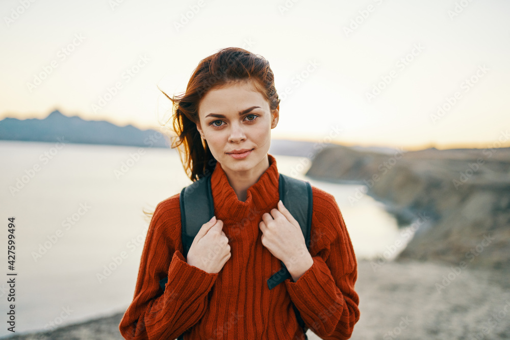 woman in the mountains outdoors resting near the sea beach sand backpack fresh air woman in the mountains outdoors resting near the sea beach sand backpack fresh air
