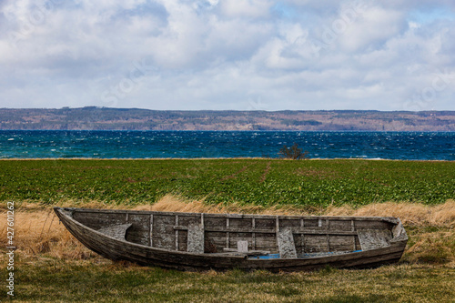 Visingso  Sweden A wooden rowboat on land with Lake Vattern in the background.
