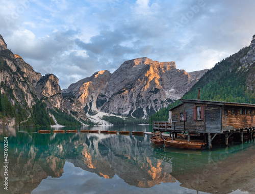 Lake Braies (Lago di Braies) in Dolomites Mountains, Boat hut on Braies Lake with Seekofel mount on background, Sunrise of Italian Alps, Naturepark Fanes-Sennes-Prags, Dolomite, Italy, Europe. 