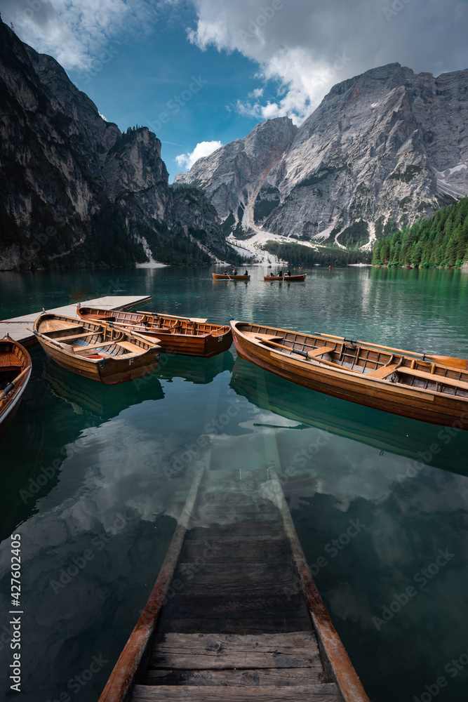 Lake Braies (Lago di Braies) in Dolomites Mountains, Boat hut on Braies Lake with Seekofel mount on background, Sunrise of Italian Alps, Naturepark Fanes-Sennes-Prags, Dolomite, Italy, Europe.
