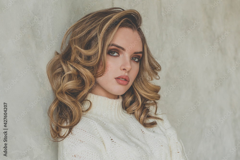 Portrait of perfect woman with blonde curly hair on gray background Portrait of perfect woman with blonde curly hair on gray background