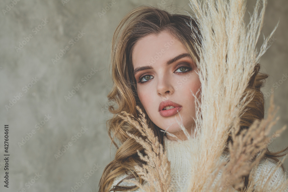 Young perfect woman face close up on gray stucco background with copy space Young perfect woman face close up on gray stucco background with copy space