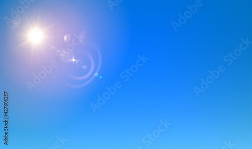 Realistic glowing sun and light flare on sky