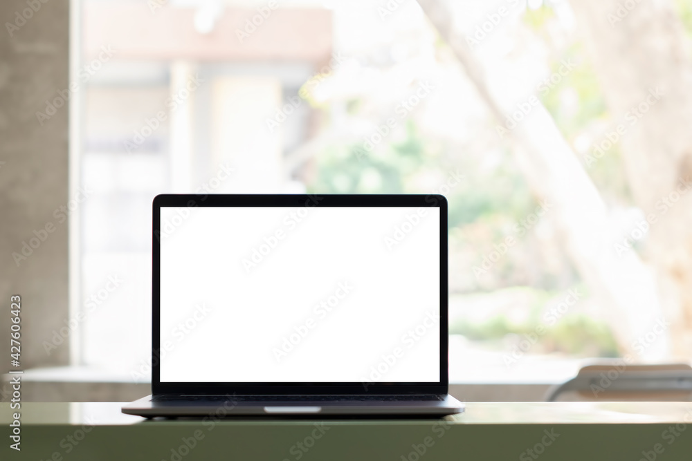 White blank screen tablet on modern working desk with garden background. White blank screen tablet on modern working desk with garden background.