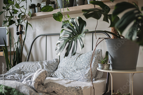 urban jungle interiour with tropical frowers in bedroom