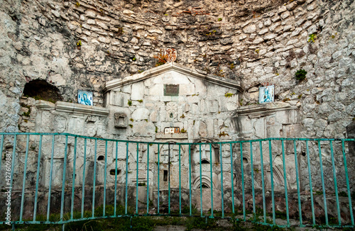 Fototapeta Naklejka Na Ścianę i Meble -  The wall of the stones of the ancient altar of the destroyed church of the IV-V century on the Iverskaya Mountain. New Athos, Abkhazia.