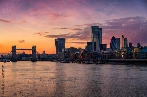 The skyline of the City of London  United Kingdom  with Tower Bridge and Thames river during dusk
