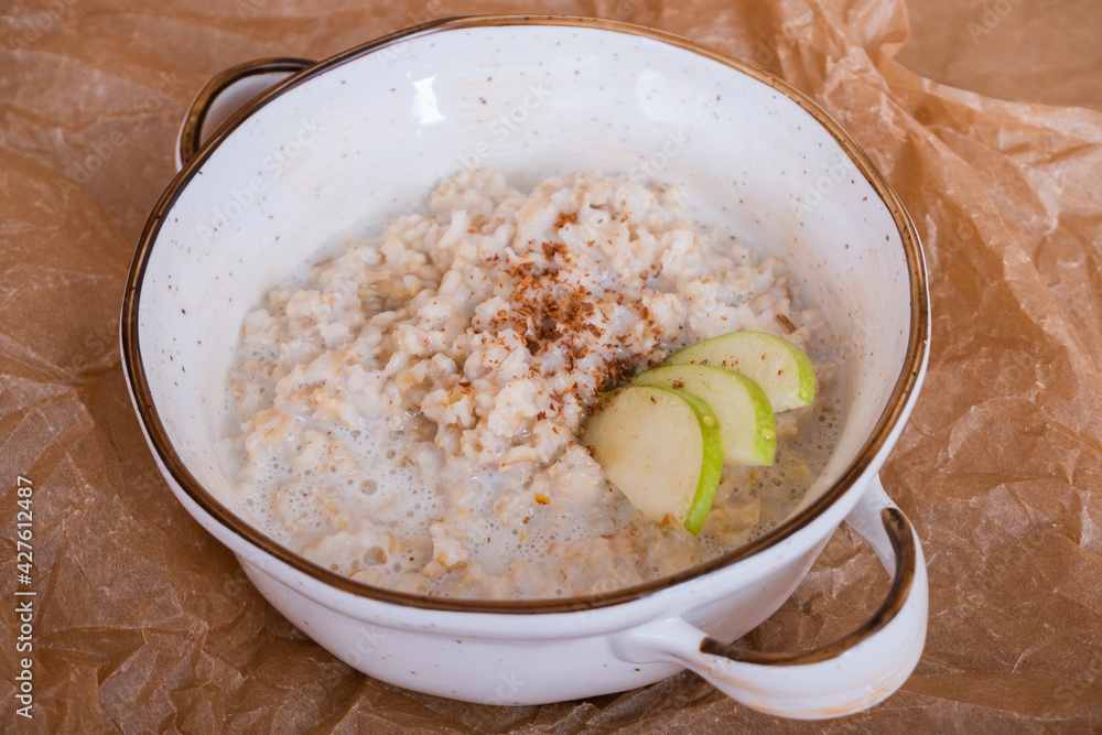 Oatmeal in milk with fruit and cinnamon. Healthy breakfast. Hercules with apples. Oatmeal in milk with fruit and cinnamon. Healthy breakfast. Hercules with apples.