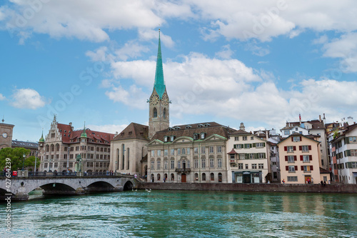 View of the Fammunster Church with the Munster Bridge over the Limmat River in Zurich, Switzerland