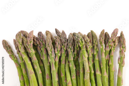 raw asparagus on white background