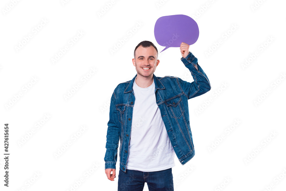 Cheerful handsome young man holding empty speech bubble Cheerful handsome young man holding empty speech bubble