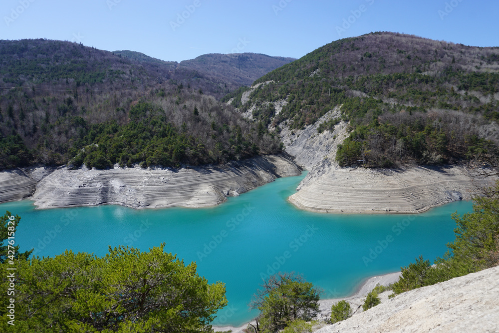 turquoise water of the shallow waters  on Serre Ponçon lake, France