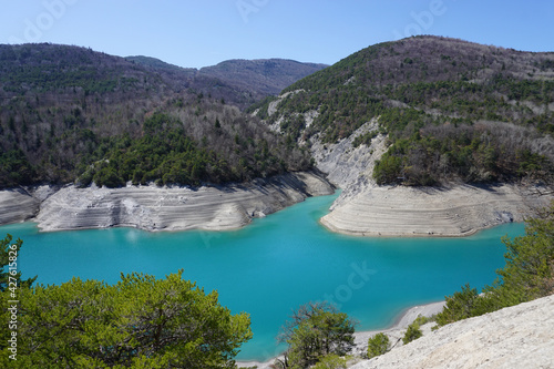 turquoise water of the shallow waters on Serre Ponçon lake, France