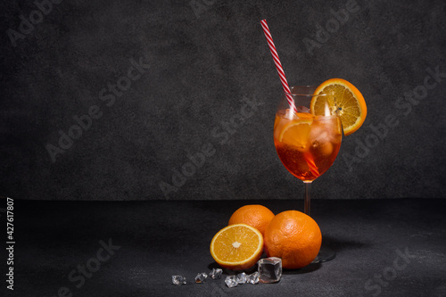 Fruit drink with ice and oranges on dark grey background with copy space. Cocktail. Cocktail Aperol spritz.