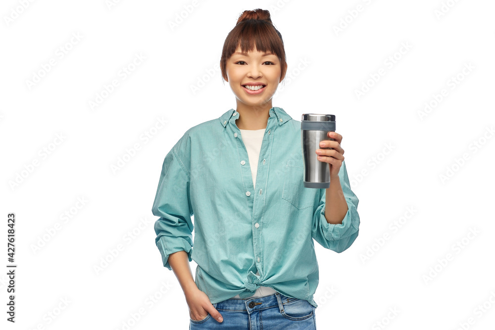 sustainability and people concept - portrait of happy smiling young asian woman in turquoise shirt with thermo cup or tumbler for hot drinks over white background