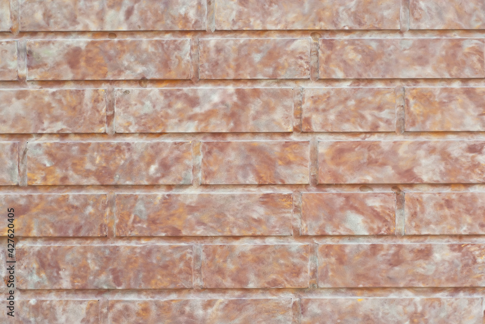 Texture of brick wall. Samples of wall or fence are presented at exhibitions. Orange brick close up.