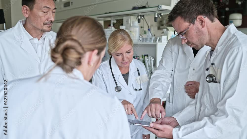 Group of scienists analyzing research results in laboratory Group of scienists analyzing research results in laboratory