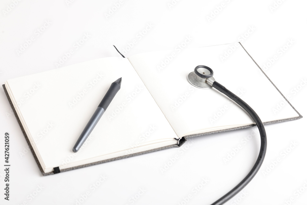 Black stethoscope lying on the diary, medicine. Black stethoscope lying on the diary, medicine.