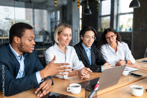 Multicultural Business People Coworkers Discussing Work Project Sitting In Office