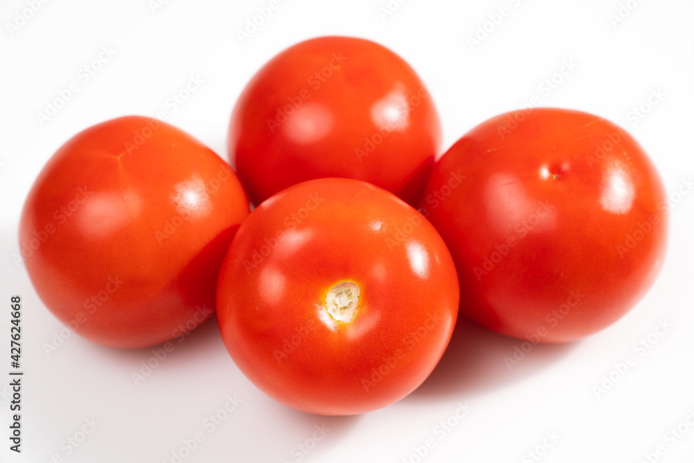 tomatoes on a white background. vegetable harvest. eco-friendly farm products. tomatoes on a white background. vegetable harvest. eco-friendly farm products.