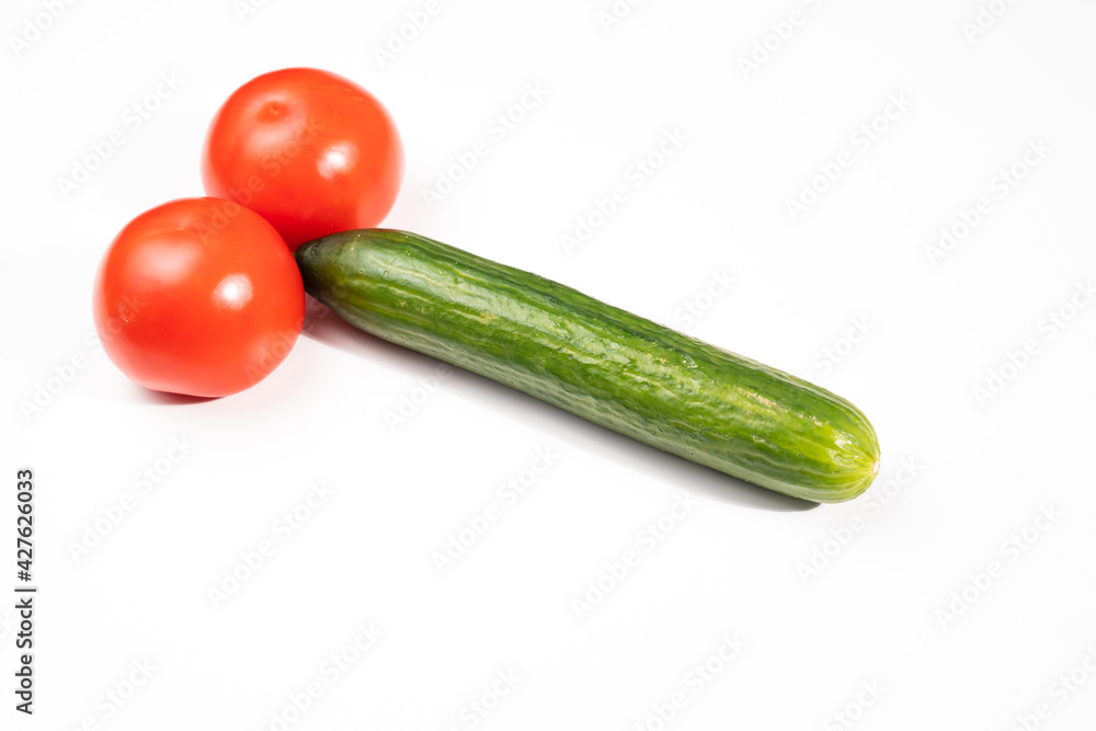 tomatoes and cucumber in the form of a male sexual organ on a white background. medications and diet for male potency. infertility problem. erotic picture. humor tomatoes and cucumber in the form of a male sexual organ on a white background. medications and diet for male potency. infertility problem. erotic picture. humor