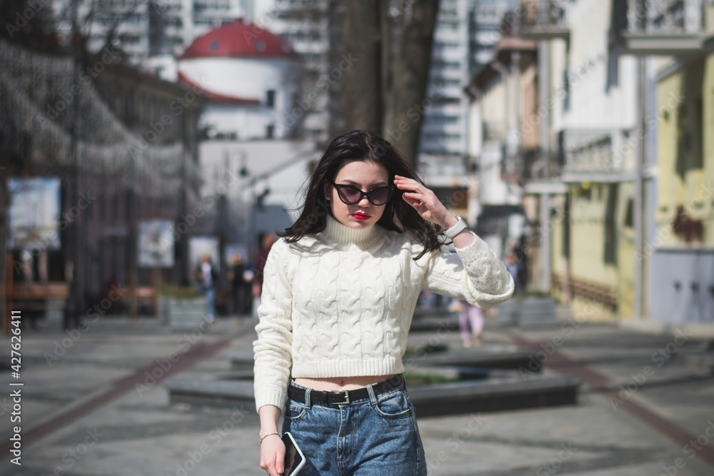 Outdoor lifestyle portrait of pretty girl