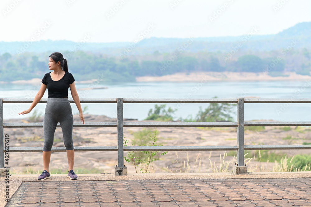 healthy pregnant woman doing yoga in nature outdoors. Prenatal yoga is a way to maintain a healthy mind and body to increase strength and flexibility.