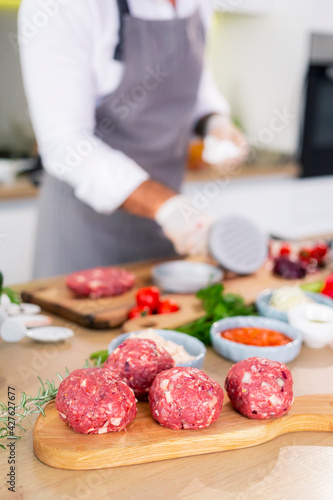 Chef preparing meatballs and putting them on a wooden board