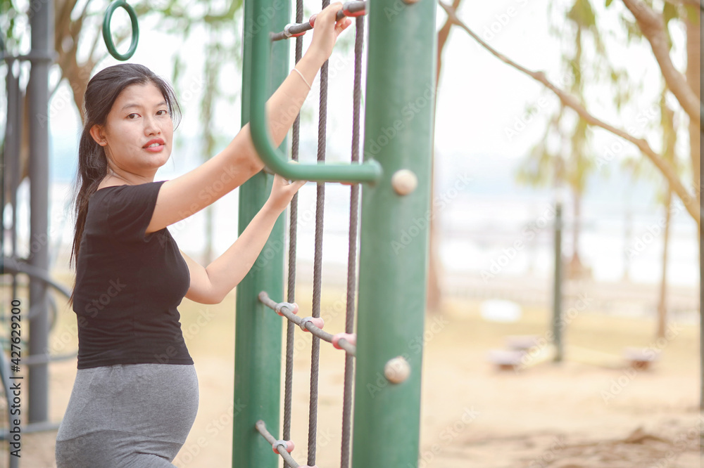 Fototapeta premium Pregnant women exercise on the playground