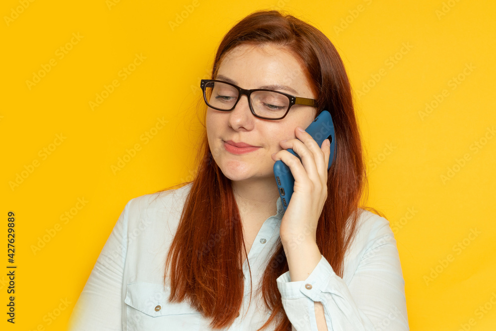 Beautiful business woman talking on a phone in the office with copyspace. Studio shot