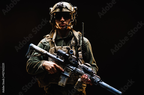 Fotografie, Obraz Special forces soldier with rifle on black background
