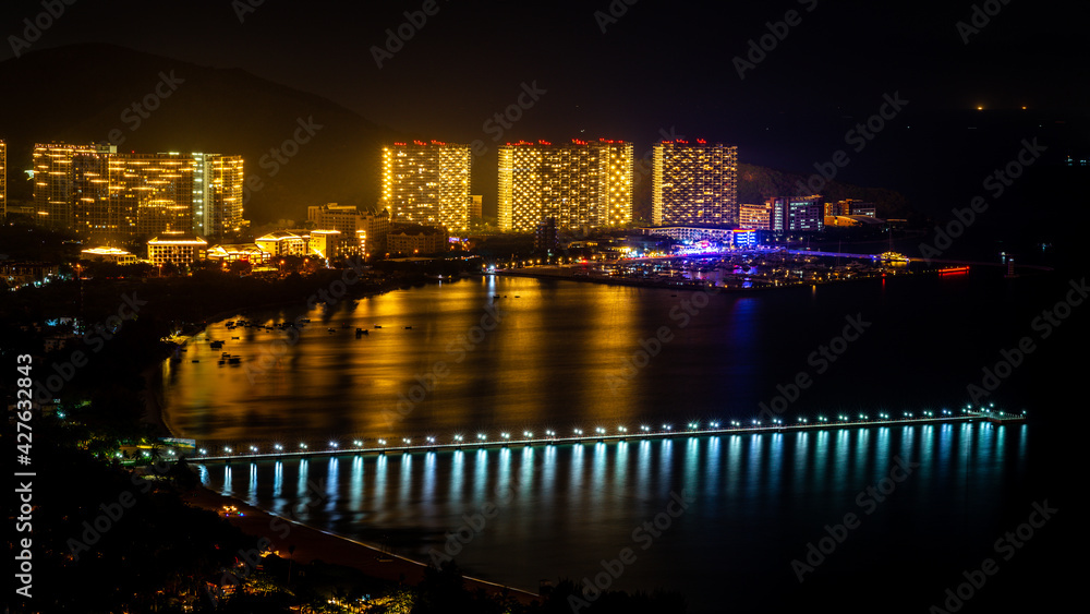 Sanya scenic nightscape with long pontoon in Sanya Bay and Banshan peninsula view in Sanya Hainan China