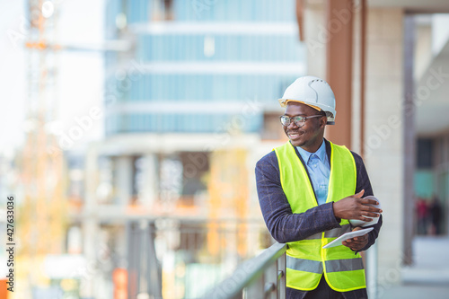 Construction Worker Planning Contractor Developer Concept. Portrait of African American Engineer at a construction work site. Successful male architect at a building site